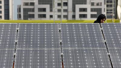 Solar panels are becoming increasingly visible on the roof of buildings in Dubai. Pawan Singh / The National