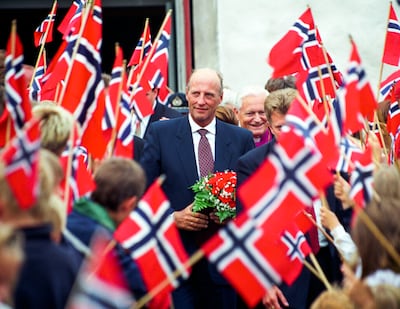 King Harald greets onlookers during a visit to Farsund, Norway, in June 1998. EPA