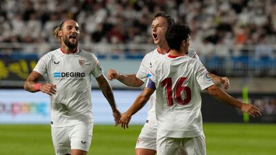 Sevilla's Ivan Rakitic, second left, celebrates levelling the scores. AP