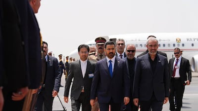 Iran's Minister of Economic Affairs and Finance, Seyed Ali Madanizadeh, right, receiving Mr Al Zaidi at the airport in Tehran. AFP