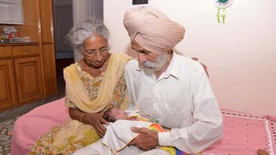 Parents Mohinder Singh Gill (R), 79, and Daljinder Kaur, 70, hold their newborn baby boy Arman at their home in Amritsar. An Indian woman who gave birth at the age of 70 said she was not too old to become a first-time mother, adding that her life was now complete. Daljinder Kaur gave birth last month to a boy following two years of IVF treatment at a fertility clinic in the northern state of Haryana with her 79-year-old husband. Narinder Nanu / AFP