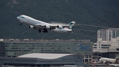 A Cathay Pacific plane takes off from Hong Kong International Airport. The airline is facing stiff competition from Chinese mainland carriers and is expected to announce job cuts this week. Jerome Favre / EPA