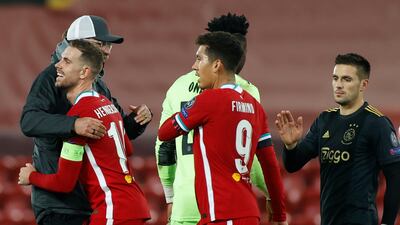 Jurgen Klopp celebrates with Jordan Henderson and Roberto Firmino after the match. AP