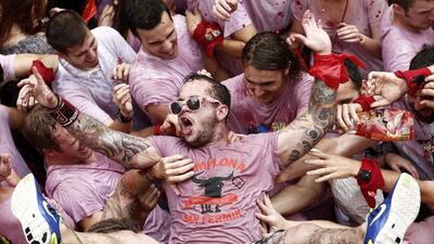 Revellers in beverage stained white T-shirts celebrate just after the rocket fire or ‘Txupinazo’ marked the start of the Festival of San Fermin (or Sanfermines) in Pamplona, Spain. Jesus Diges / EPA