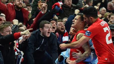 Liverpool’s Brazilian midfielder Philippe Coutinho (2R) celebrates with the crowd after scoring their first goal to equalise 1-1 during the English League Cup final football match between Liverpool and Manchester City at Wembley Stadium in London on February 28, 2016. AFP / BEN STANSALL