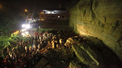 Rescue workers and paramilitary forces search for survivors in the rubble of a landslide in the Gulistan-i-Jauhar area in Karachi. Athar Hussain / Reuters