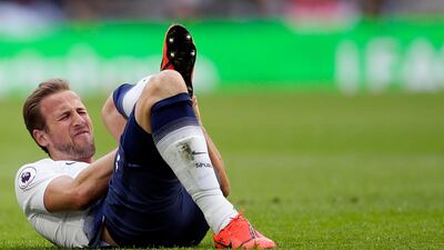 Kane lies on the pitch in pain. AP Photo