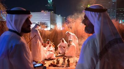 Emirati men chat while gahwa, or traditional coffee, is being brewed at Qasr Al Hosn on the opening day. Silvia Razgova / Crown Prince Court