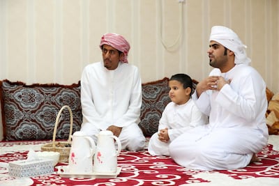 The sons of Eida Al Darei presents guests with Omani halwa from the city of Nizwa. Like many Qoa residents, Eida maintains close contacts with her native Oman. Chris Whiteoak / The National