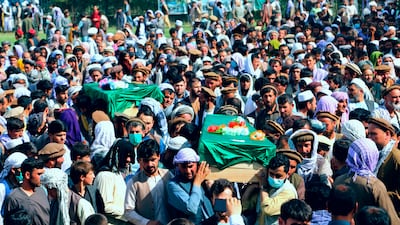 Afghans carry the body of civilians killed during fighting between the Taliban and national security forces in Badakhshan province, northern Afghanistan, on July 4, 2021. AP