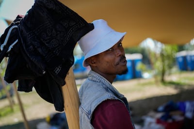 A man lingers in the shade with temperatures into the 30s. AP