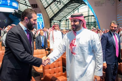 Syria's President Ahmed Al Shara meets with Saudi Crown Prince Mohammed bin Salman as Donald Trump Jr looks on during the Future Investment Initiative (FII) conference in Riyadh on October 29, 2025. AFP
