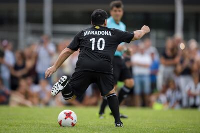 Former Argentinian football star Diego Maradona controls the ball during "The Gianni's game, the match of legends", a football match with football legends in honour of FIFA's President on July 7, 2017 in Brig. / AFP PHOTO / Fabrice COFFRINI