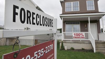 A foreclosure sign stands outside a home in Winchester, Virginia, US. At the height of the financial crisis in 2009, mortgage delinquencies and foreclosures rose to record highs. Jay Mallin / Bloomberg
