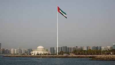 The Abu Dhabi skyline and the UAE flag.