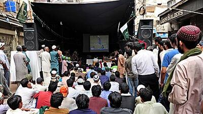 Image Pakistani fans watch the semi-final match against India on a giant screen in Karachi yesterday. The government declared half-day holiday in offices and schools to enable the cricket-loving people to enjoy the exciting moments of the match.