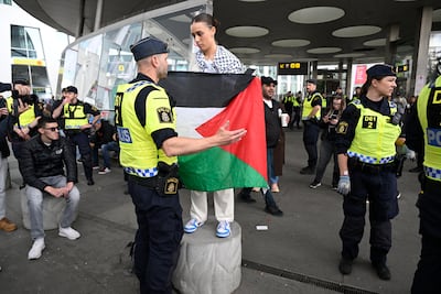 A Swedish police officer and a pro-Palestinian demonstrator protesting against Israel's participation in the Eurovision Song Contest, in Malmo, Sweden, in May 2024. EPA