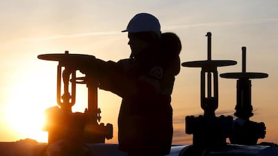 A worker checks the valve of an oil pipe at an oilfield outside the West Siberian city of Kogalym. Russia has been slow to contribute in the global production cut agreed late last year. Sergei Karpukhin / Reuetrs