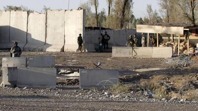 Afghan security forces stand guard at the entrance gate of Kandahar airport which was stormed by Taliban militants on December 9, 2015. At least 37 people were killed in the attack. Reuters