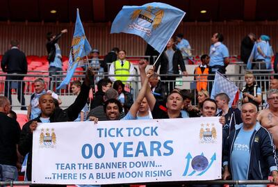 Manchester City fans celebrate with their own banner after beating Stoke City to win the FA Cup in 2011 - their first major trophy in 35 years. Getty