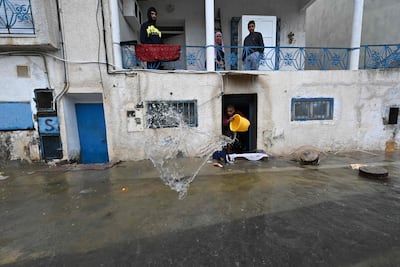 A man removes water from his flooded home in La Goulette, near the Tunisian capital Tunis. AFP