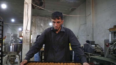 Traditional sweets being prepared at a bakery run by displaced Syrians in the town of Dana, east of the Turkish-Syrian border in the northwestern Idlib province. Aaref Watad / AFP