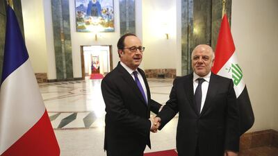 Iraq’s Prime Minister Haider Al Abadi, right, greets French President Francois Hollande prior to their meeting in Baghdad. Christophe Ena / AP Photo