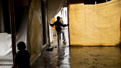Akram plays with a football at Khabarto Camp in Dahuk, Iraq.