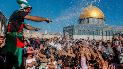 A clown entertains Palestinians on the first day of Eid al-Adha near the Dome of Rock mosque at the Al-Aqsa Mosque compound, Islam's third most holy site, in the Old City of Jerusalem. AFP