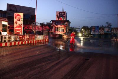 Afghan municipality workers clean the scene of a suicide bomb attack in Kunduz, Afghanistan, on August 31, 2019. EPA