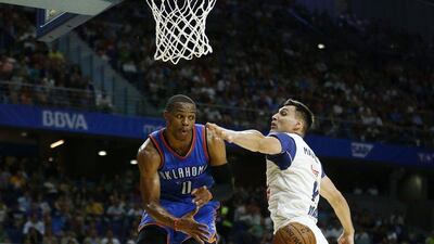 Real Madrid small forward Jonas Maciulis, right, tries to block a pass by Oklahoma City Thunder guard Russell Westbrook. Daniel Ochoa de Olza / AP