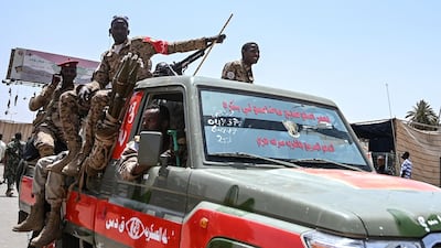 Members of Sudan's Rapid Support Forces stand guard while demonstrators stage a sit-in outside the army headquarters in Khartoum. AFP