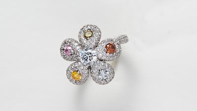 A ring shaped like a flower, in white and coloured diamonds