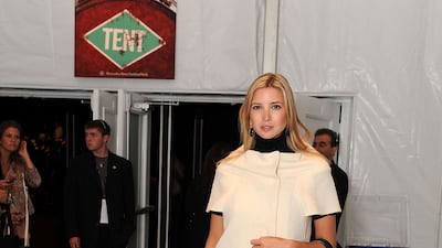 Ivanka Trump, wearing a white coat dress over a polo-necked black dress, attends New York Fashion Week on September 10, 2009. Getty Images