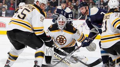 Tim Thomas, centre, has been on impressive form in goal this season for the Boston Bruins.