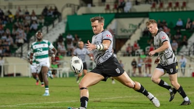 UAE fullback Conor Kennedy, playing against Zimbabwe, the country of his birth, kicks the ball away during the Test match at The Sevens, Dubai, November 5, 2024. Photo: Allison Buckley
