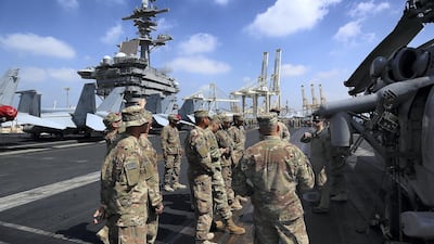 Members of the crew stand on the flight deck for the USS Theodore Roosevelt which has made port in Dubai. Satish Kumar for The National