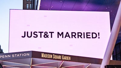 Madison Square Garden is illuminated in pink, with a digital display announcing Taylor Swift and Travis Kelce's wedding. EPA