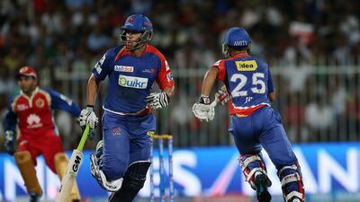 Ross Taylor, left, and J P Duminy of Delhi Daredevils running between the wickets during the IPL match between Royal Challengers Bangalore and Delhi Daredevils at Sharjah Cricket Stadium in Sharjah. Pawan Singh / The National
