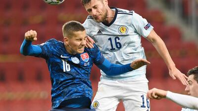 Scotland’s Liam Cooper battles for the ball with Slovakia’s Lubomir Satka. Reuters