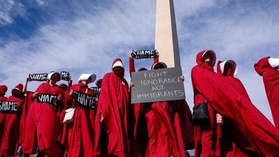 Handmaids Army DC gather at the Washington Monument for the 'Trump Must Go' protest. Getty Images