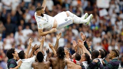 Real Madrid players throw Karim Benzema in the air after the match. Reuters