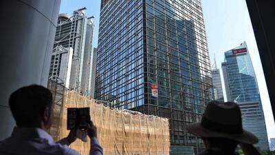 People watch as Robert climbs the building. AFP