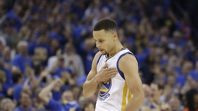 Golden State Warriors guard Stephen Curry reacts after making a three point basket during the first half of an NBA basketball game against the Memphis Grizzlies in Oakland, California, Wednesday, April 13, 2016. (AP Photo/Marcio Jose Sanchez)