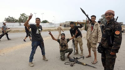 Fighters loyal to Libya's Government of National Accord gesture during clashes south of the Tripoli. AFP