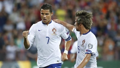 Portugal's Cristiano Ronaldo, left, celebrates with his teammate Fabio Coentrao after scoring a penalty goal against Armenia during their Euro 2016 group I qualifying match in Yerevan, Armenia June 13, 2015. REUTERS/David Mdzinarishvili