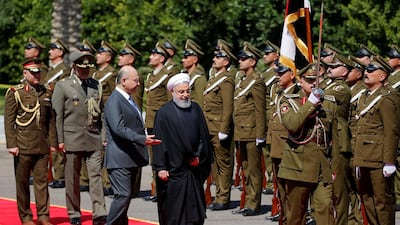 Iraq's President Barham Salih walks with Iranian President Hassan Rouhani during a welcome ceremony at Salam Palace in Baghdad, Iraq. REUTERS