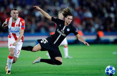 FILE - In this Oct. 3, 2018, file photo, PSG midfielder Adrien Rabiot is challenged by Red Star's Nenad Krstici, left, during a group C Champions League soccer match between Paris Saint Germain and Red Star Belgrade at the Parc des Princes stadium in Paris. Coach Thomas Tuchel needs Rabiot back in the side because an injury to Marco Verratti left Paris Saint-Germain seriously short of options in midfield. (AP Photo/Francois Mori, File)