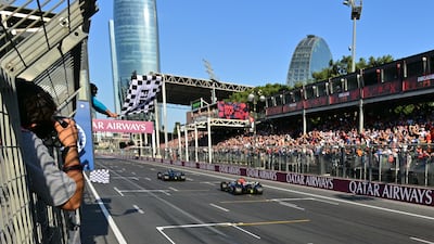 Mercedes' George Russell takes the chequered flag ahead of Dutch driver Max Verstappen of Red Bull, AFP