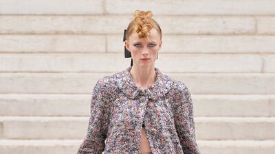 A coat of sequins is worn over a skirt made from feathers at Chanel.